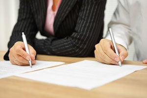 Couple Signing Document